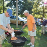Andrew Dobbins and Bill Dobbins grill the hotdogs for free hotdog night!