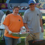 Emily Verbeke and Andrew Dobbins serve up free hot dogs to concert attendees